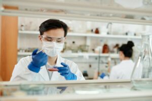 scientist culturing bacteria in petri dish
