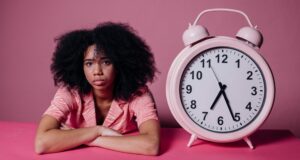 african american women next to large alarm clock